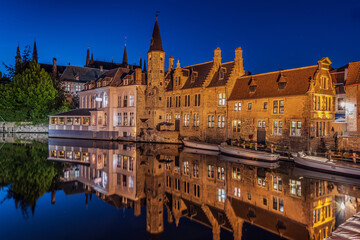 Illuminated houses on the canal in Bruges in the evening. Rosary Quay in the center of the old town...
