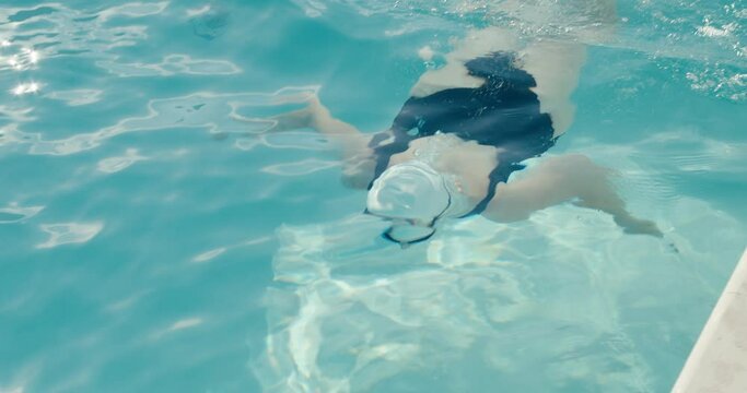 Woman swimmer start swimming pool water swim dolphin kick in close up
