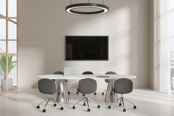 Cozy conference interior with table and armchairs, tv screen and window