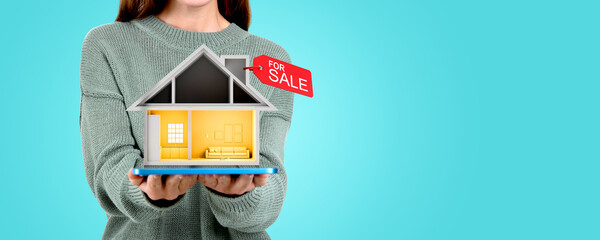 Woman with digital tablet and cartoon house with a tag for sale