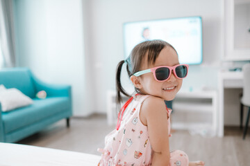Portrait of a cute little girl wearing sunglasses. Smile child.