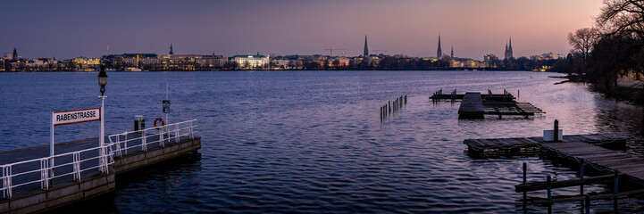 As the sun sets over Hamburg Rotherbaum, Rabenstraße Alster boat dock pier offers a panoramic view...