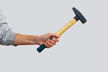Woman's hand holdin a hammer on an isolated white background. Showing woman empowerment