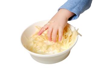 Funny child eating a grated apple with his hand from a plate, close-up, isolated on white background. Hungry baby boy eats fruit, humor. Kid aged one year and three months