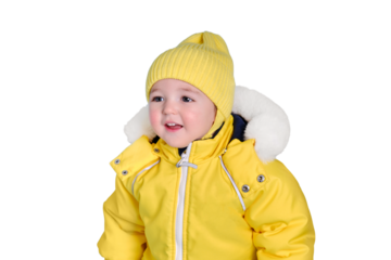 Happy toddler baby in winter clothes snowsuit isolated on a white background. A child in a warm yellow jumpsuit with a hood. Kid aged one year five months