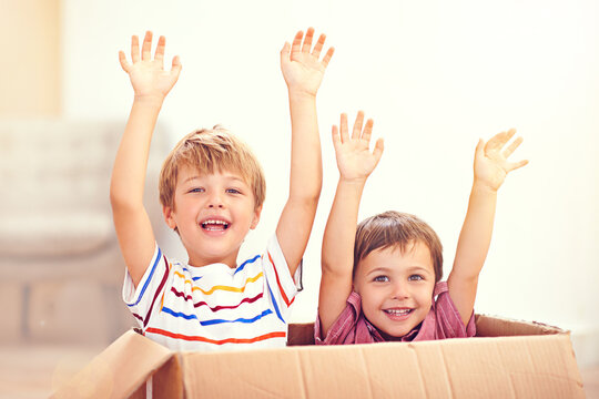 Children, box or portrait of siblings playing in house for fun, bonding or hands up game. Cardboard, learning and excited kids in living room for celebration, imagine or rollercoaster fantasy at home