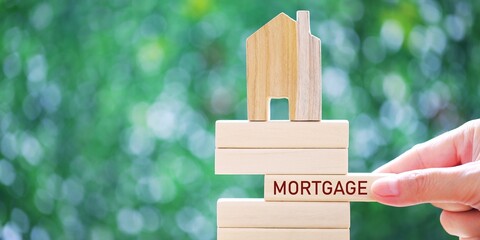 "MORTGAGE" word made with building blocks on green background.