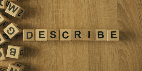 Describe word made with building blocks. Wooden Blocks with the text: Describe. The text is written in black letters.