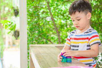 Cute little boy playing with colorful magnetic constructor toy.  Copy space.