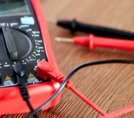 A screwdriver lies on a multimeter measuring device