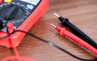 A screwdriver lies on a multimeter measuring device