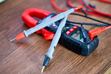 A screwdriver lies on a multimeter measuring device