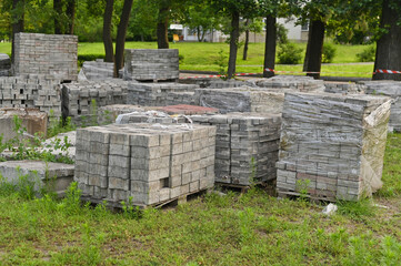 Gray bricks are stacked into cubes. White blocks of brick in stock on Warehouse bricks.