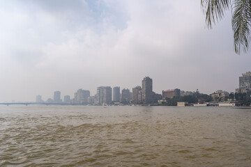 Cairo, Egypt - October 27, 2022. Views of the buildings and the Nile river in a foggy day in the old Cairo city