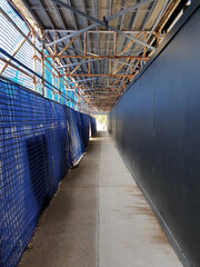 covered footpath with scaffolding at construction site