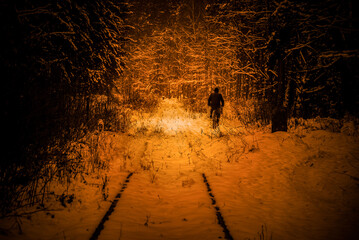 WINTER ATTACK - An old railway road covered with snow and a cyclist on forest road