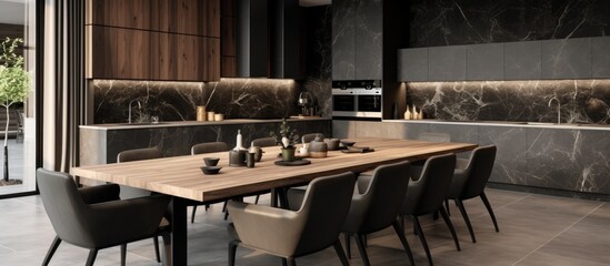 The dining room features a wooden table surrounded by gray chairs on a black marble floor. The beige walls and grey countertops add to the stylish interior design.