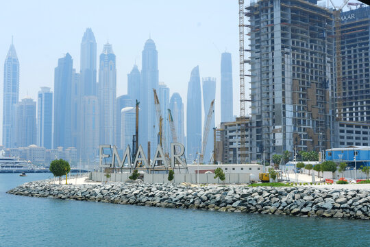 The expanding skyline of Dubai Marina, featuring the Emaar sign, with clear views of ongoing construction and high-rise buildings. Dubai, UAE - August 15, 2023