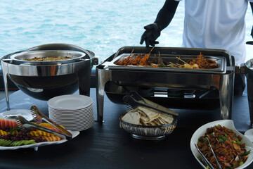 Yacht Catering Service with Ocean View. Buffet setup on a yacht featuring a variety of dishes with...