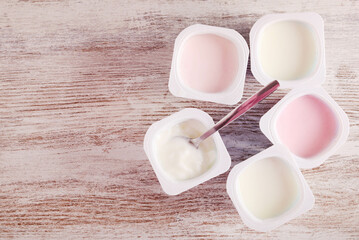 Assorted yogurt in plastic cups