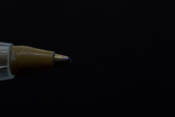 Detail of blue ink pen tip horizontally with black background and copy paste