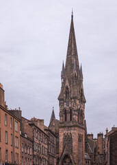 The impressive spire of Barclay Viewforth Church stands tall above the historic residential architecture of Edinburgh, under a blanket of soft grey clouds (Vertical photo)