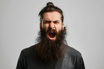Close up portrait of angry mad young man with long beard shouting isolated on light grey background - obrazy, fototapety, plakaty