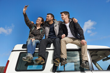 Friends, car and selfie in smile with smartphone for adventure, holiday and road trip to travel in...