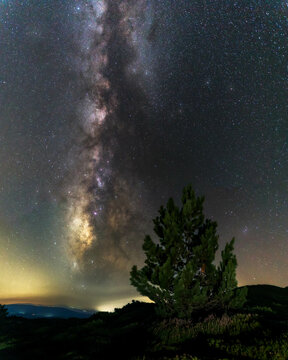 night sky with the Milky Way in a vertical position with a peak in the foreground in Alto de la Cruz in the Sierra de La Demanda
