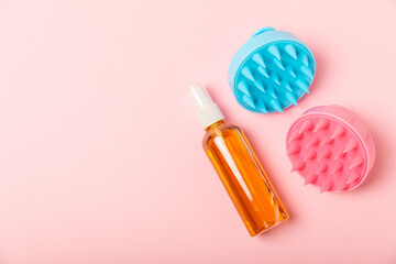 Brush for scalp massage on a pink background. Brush for hair growth stimulating brush. Hair massage. stimulating brush. Hair care, head relaxation concept. Copy space.