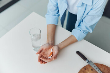 Woman Holding Pill and Glass of Water Medication Concept with Female Hand, Medicament Tablet and...