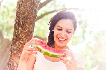 Woman eating a refreshing slice of watermelon