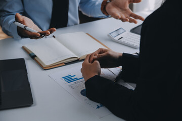 Business team working with new startup project plan and discussion information for financial strategy with laptop and digital tablet in a modern business lounge.