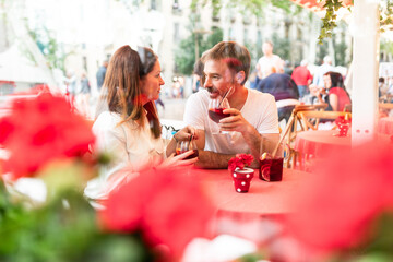 Romantic couple enjoying drinks outdoor cafe in Barcelona