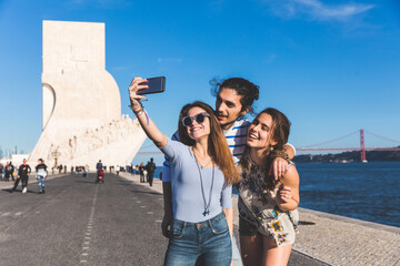 Friends travelling and taking a selfie together in Lisbon
