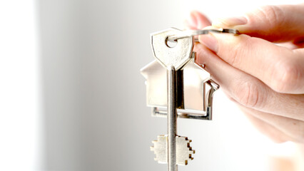 keys to a house or apartment in the hands of a realtor girl in