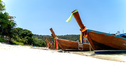 Thai national boat near the sandy beach in