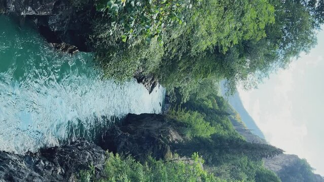 The Bolshaya Laba River. A mountain emerald river in a narrow, sunlit canyon. Bolshaya Laba River near the village of Psemen in Karachay-Cherkessia, Russia. Panoramic view. 4K