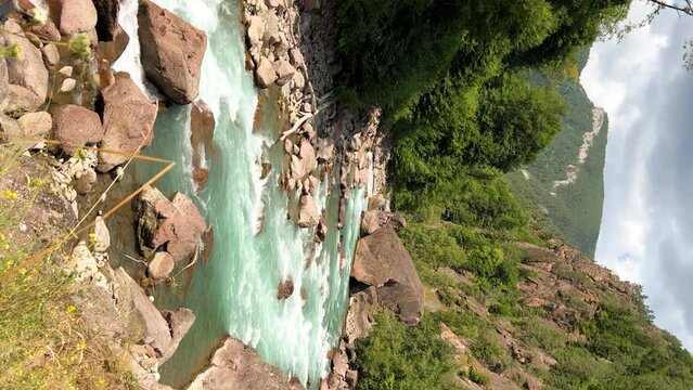 The Bolshaya Laba River. A mountain emerald river in a narrow, sunlit canyon. Bolshaya Laba River near the village of Psemen in Karachay-Cherkessia, Russia. Panoramic view. 4K
