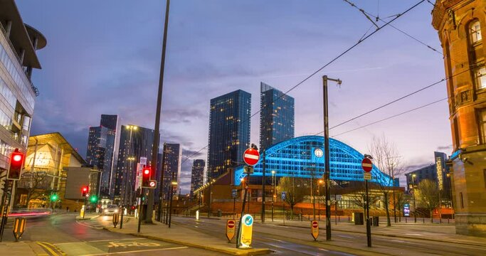 Time lapse video of Lower Mosley st Manchester showing trams and cars moving and sunset behind the skyscrapers. 