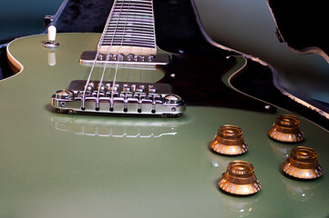 Close-up of a high gloss metallic sage green guitar