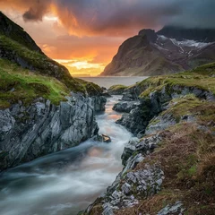 Fotobehang A stormy stream in a mountain gorge at sunset. The White Sea coast. Wonderful colorful mountain landscape. © Rogoz