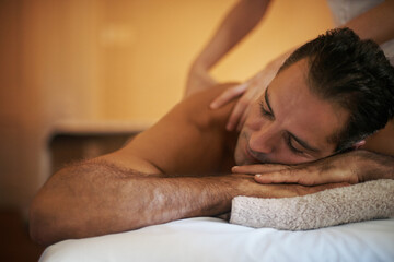 Relax, massage and man at hotel spa for health, wellness and balance with luxury holistic...