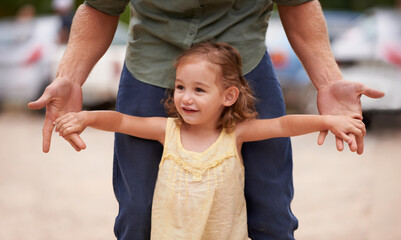 Fototapeta premium Father, child and hand holding for nature holiday for bonding love support with parent development, trust or connection. Male person, daughter and together for dad adventure, happiness or playing
