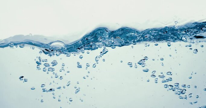 Many bubbles in water close up, abstract water wave with bubbles in slow motion