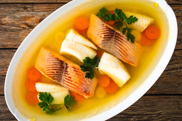 Roast salmon and halibut in jelly with vegetables on white background
