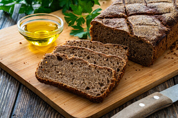 Loaf of homemade, fresh baked cottage rye bread on wooden table
