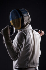 Ukrainian fencer on a black background