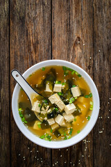 Miso soup - traditional Japanese soup with tofu on wooden table
