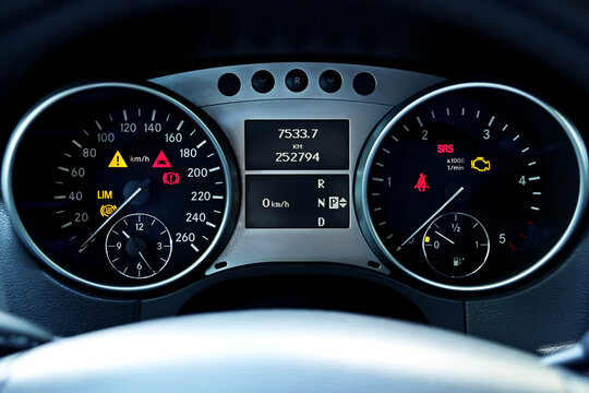 Dashboard car close-up. Car speedometer with illuminated. Screen display of car status warning light on dashboard panel symbols which show the fault indicators